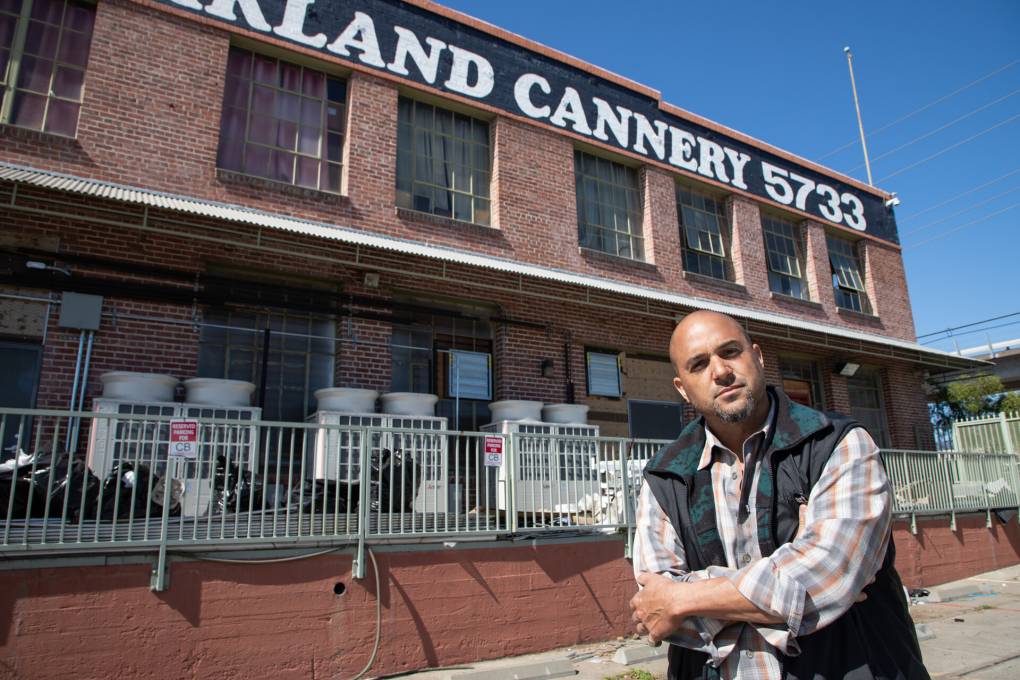Alistair Monroe poses for a portrait outside of The Cannery in East Oakland on Mar. 17, 2022.